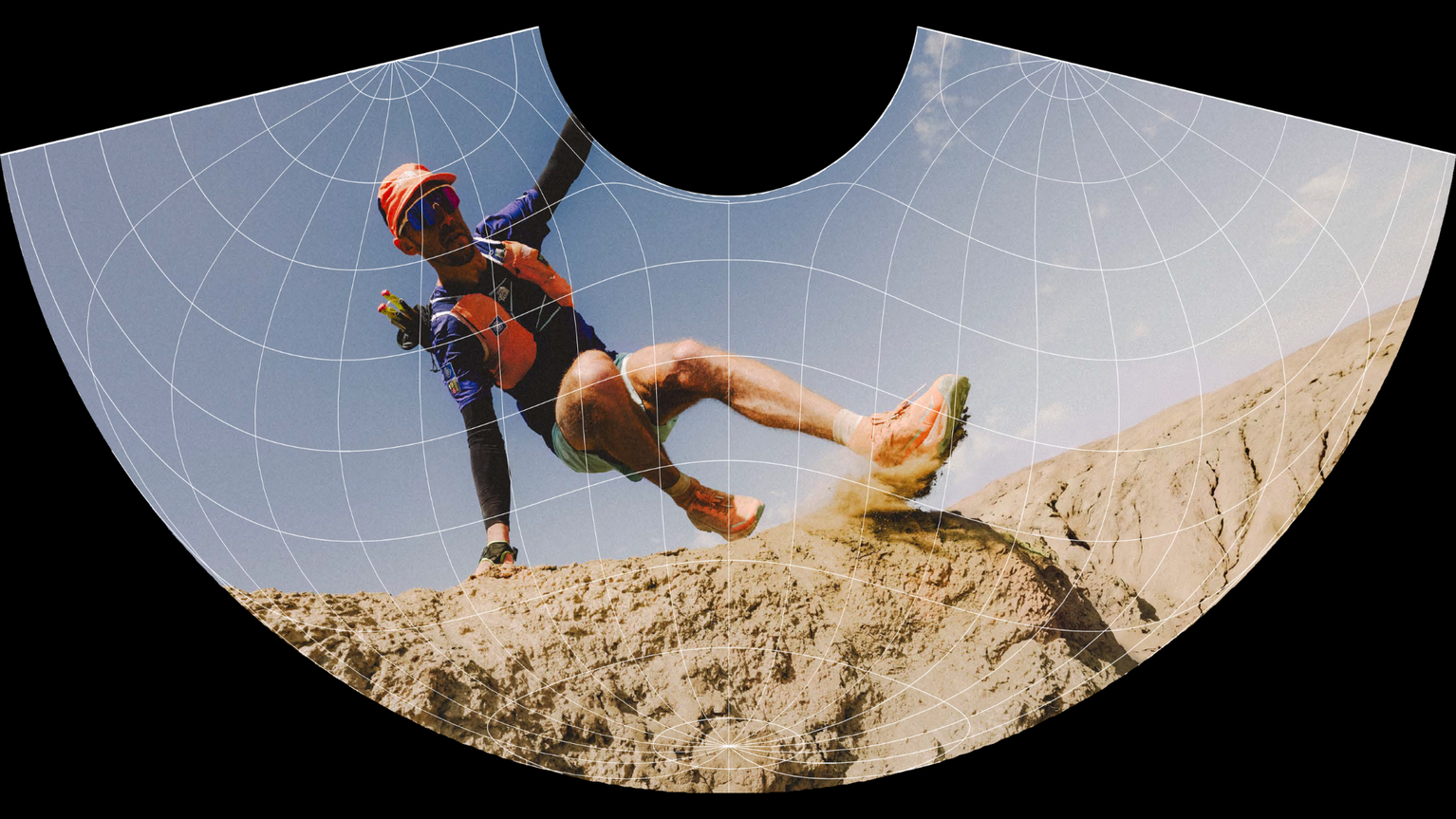 Trail runner in vibrant gear skillfully navigating rocky terrain under a clear sky, with dust trailing behind.
