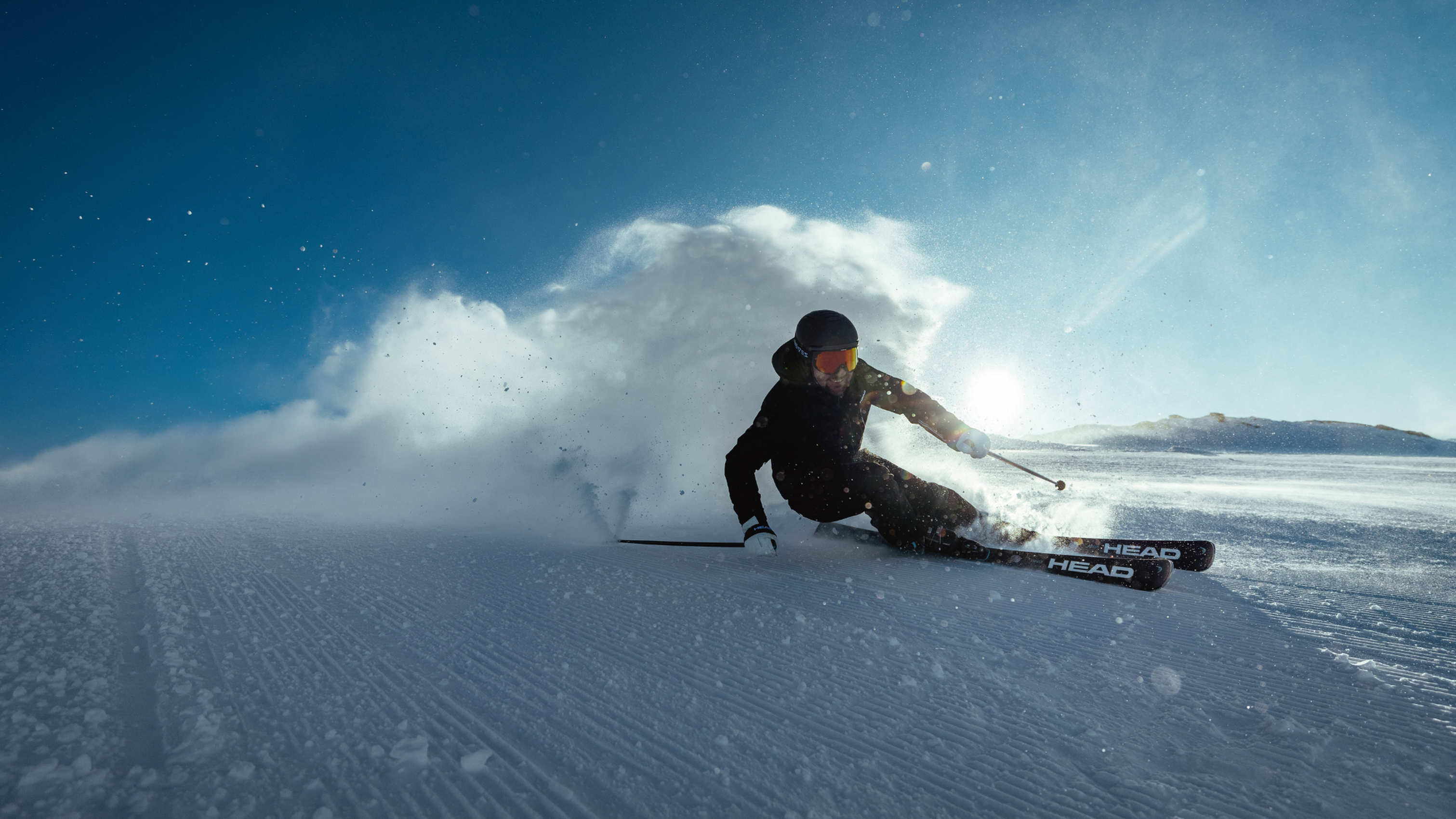 Downhill skier on a groomed piste