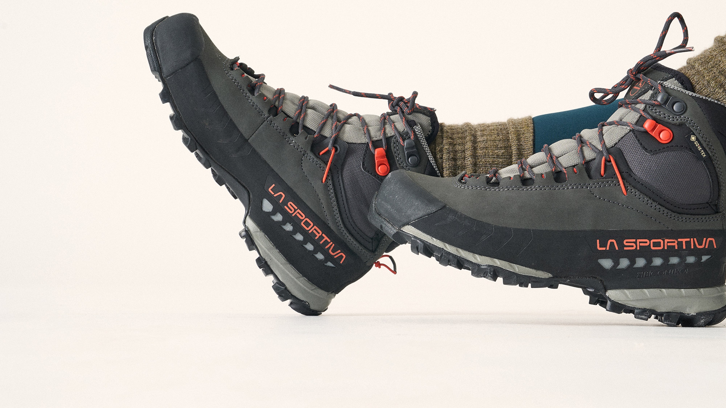 Close-up of gray and black La Sportiva hiking boots worn with brown socks.