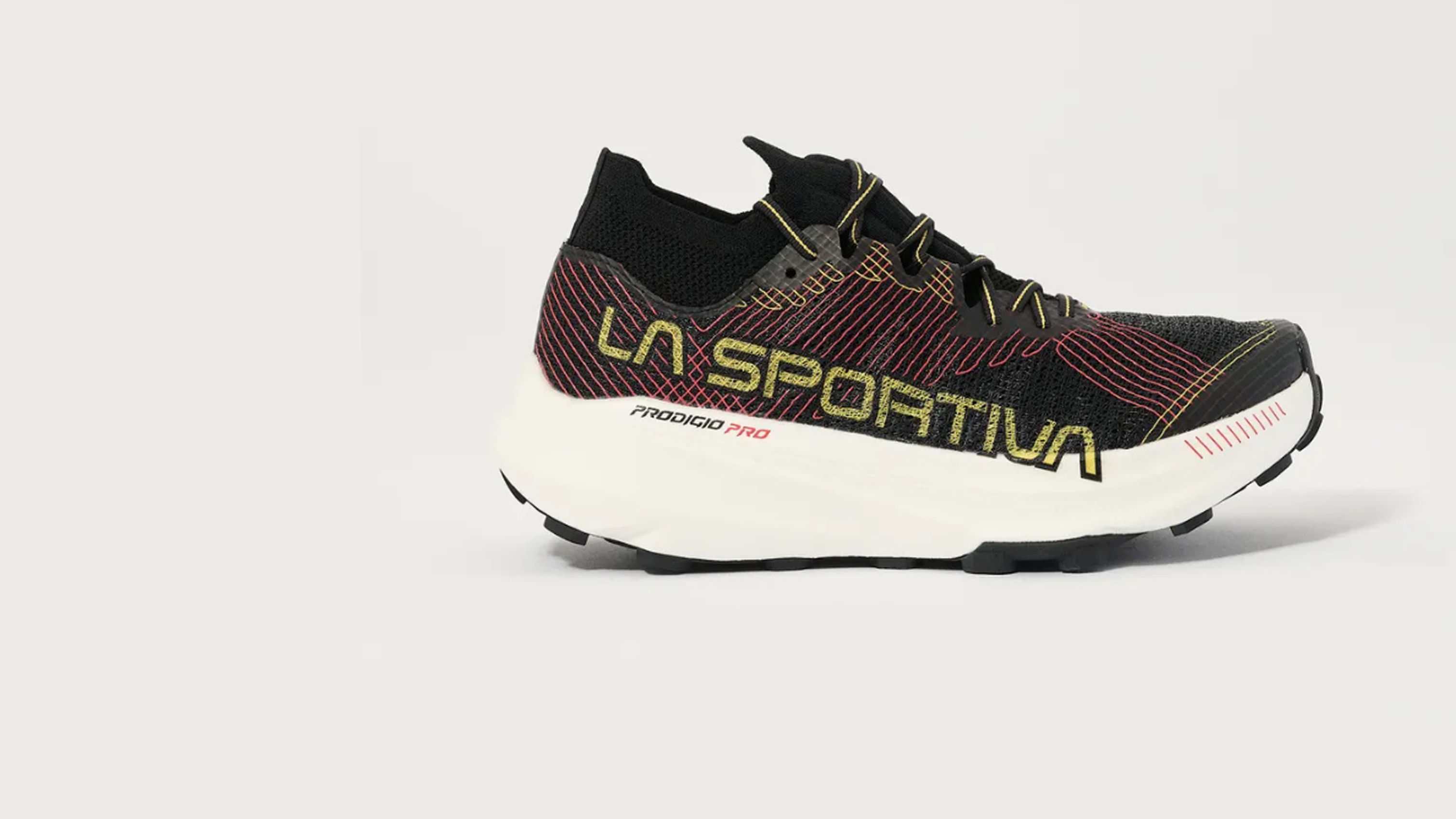 Black and red La Sportiva running shoe with white sole, featuring yellow and red details and "Prodigio Pro" text on the side.