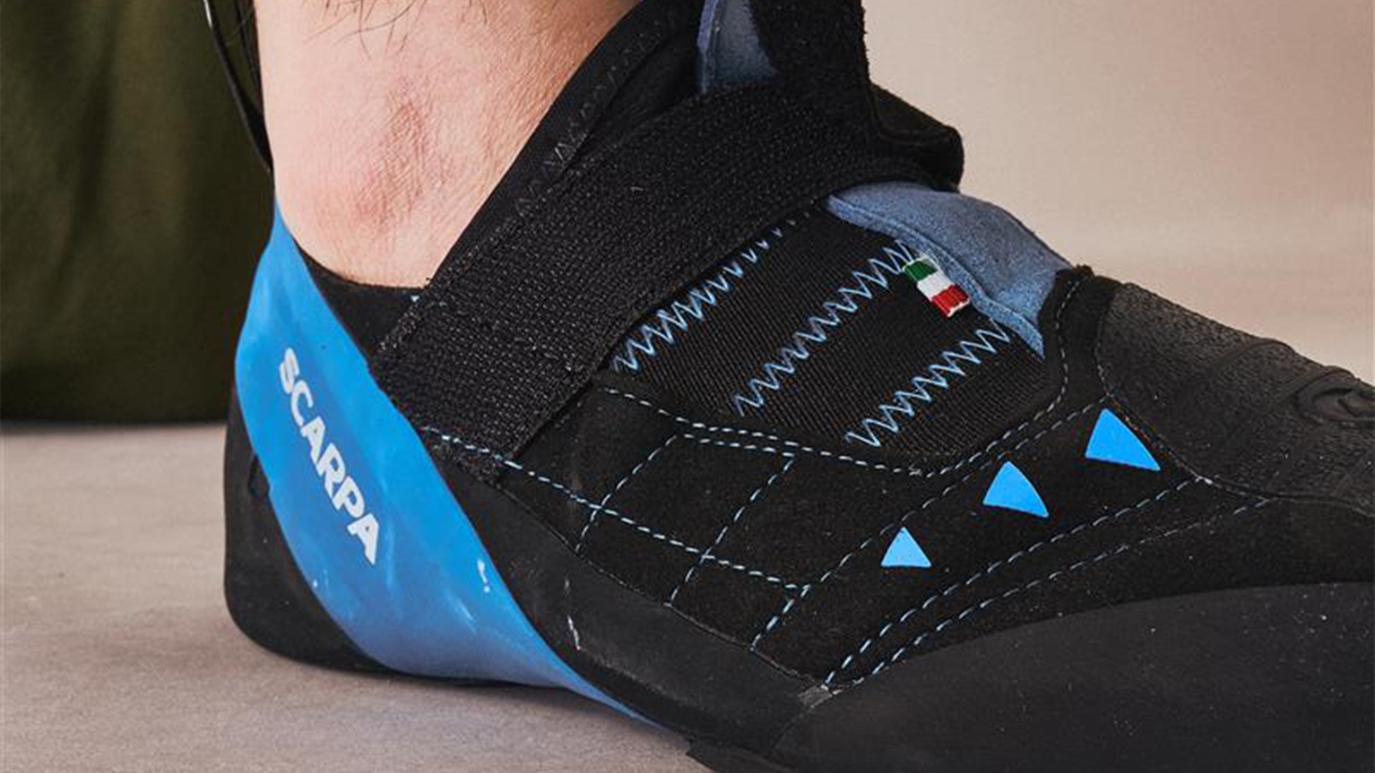 close up of a black and blue Scarpa climbing shoe