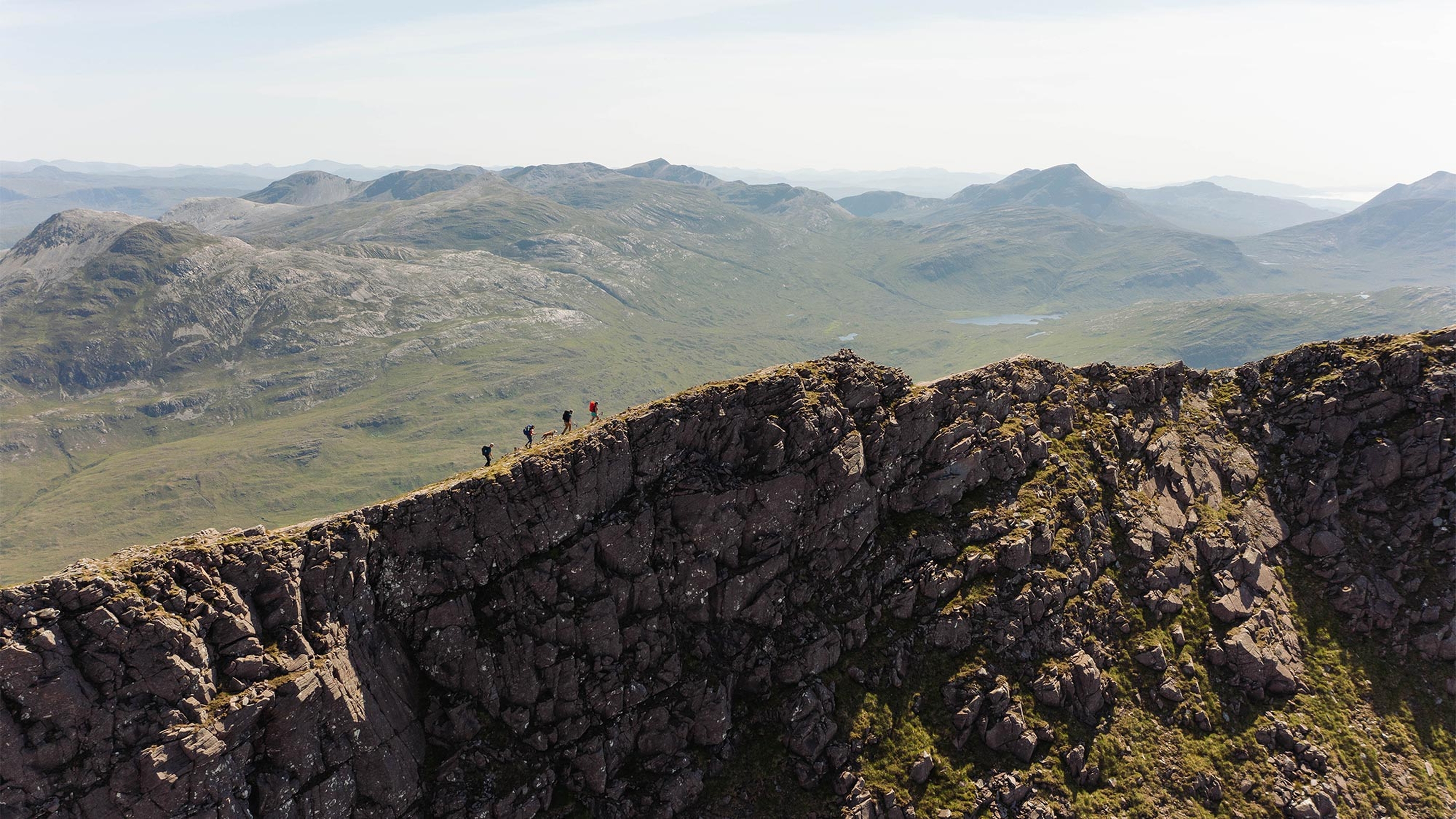 4 people walking along a ridge