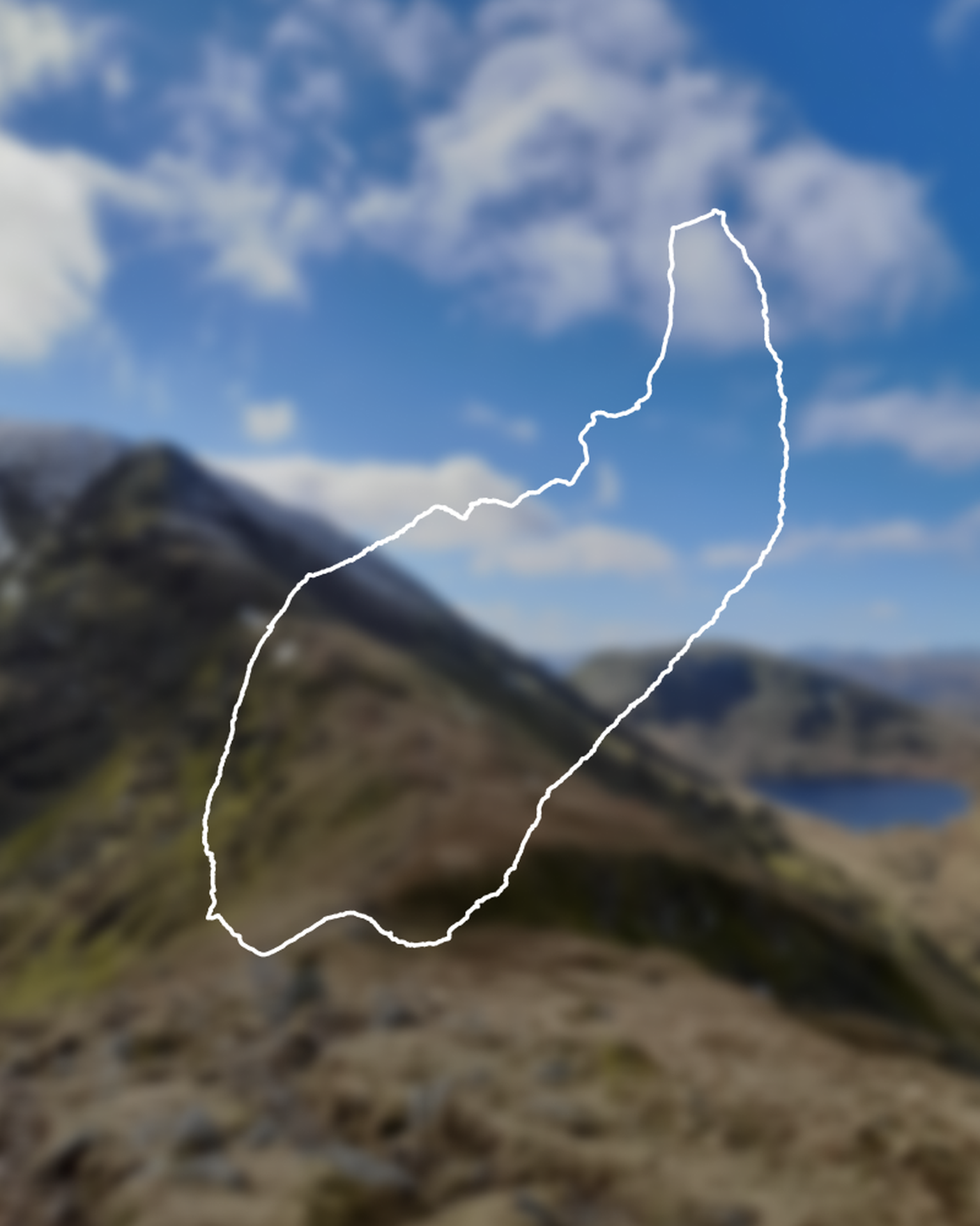 Outline of a walking route overlaid on a blurred mountainous landscape with a partly cloudy sky.