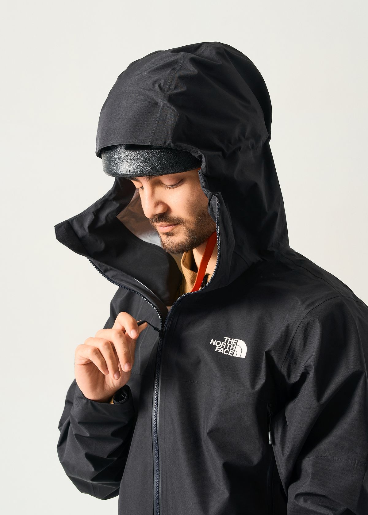 Adjustable helmet compatible hood