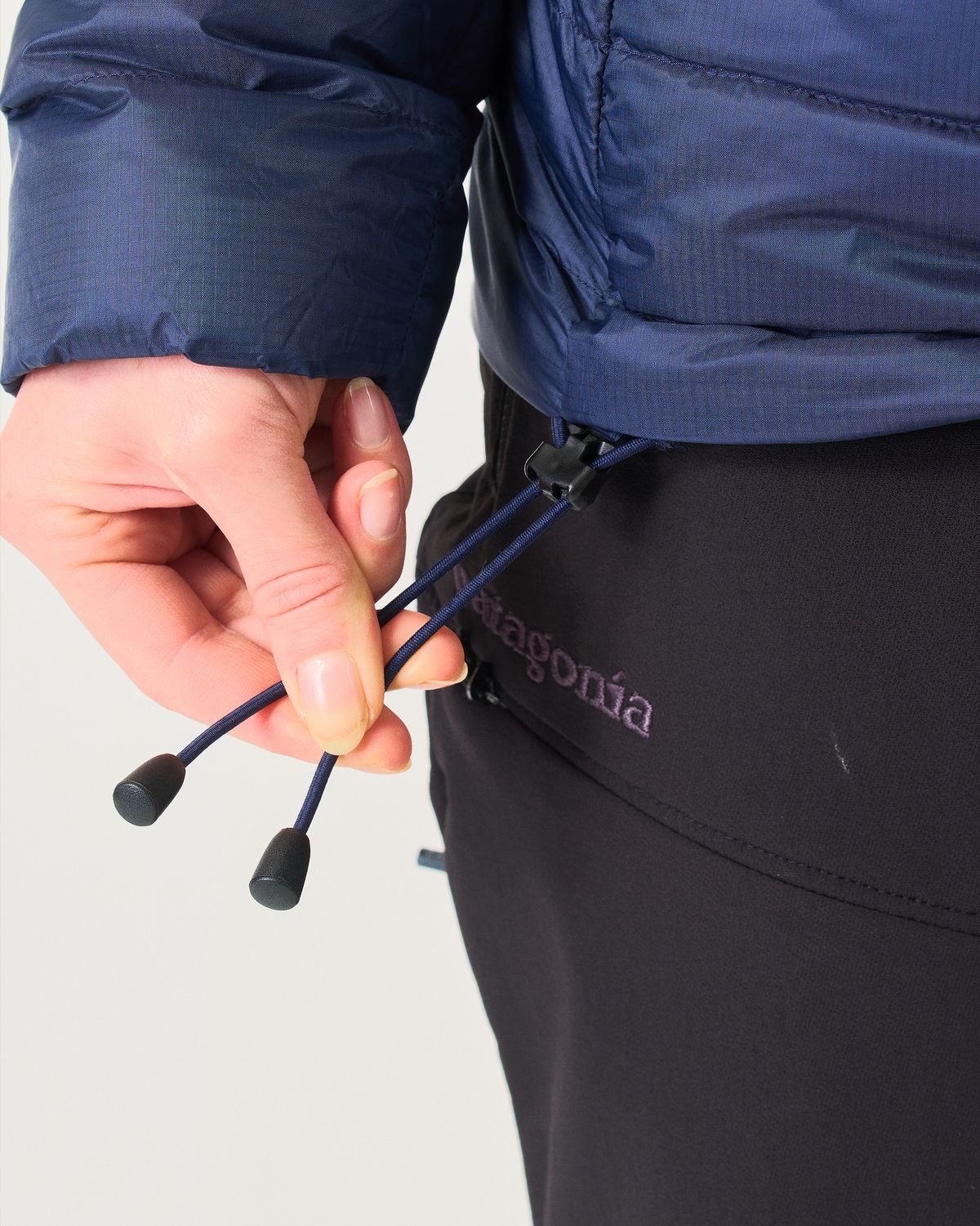 Dual tether hem drawcords