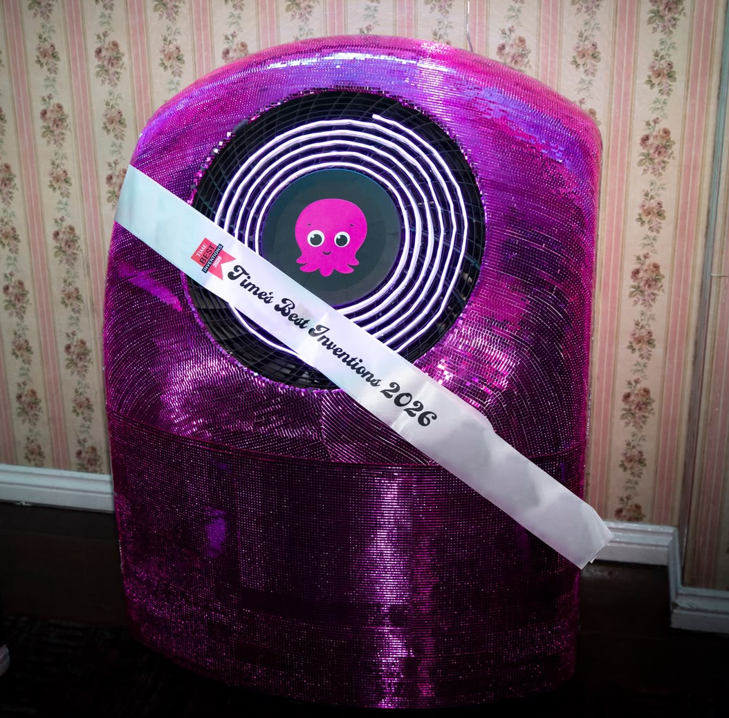 A picture of a Cosy heat pump covered in sequins and with a TIME's Best Inventions 2026 sash