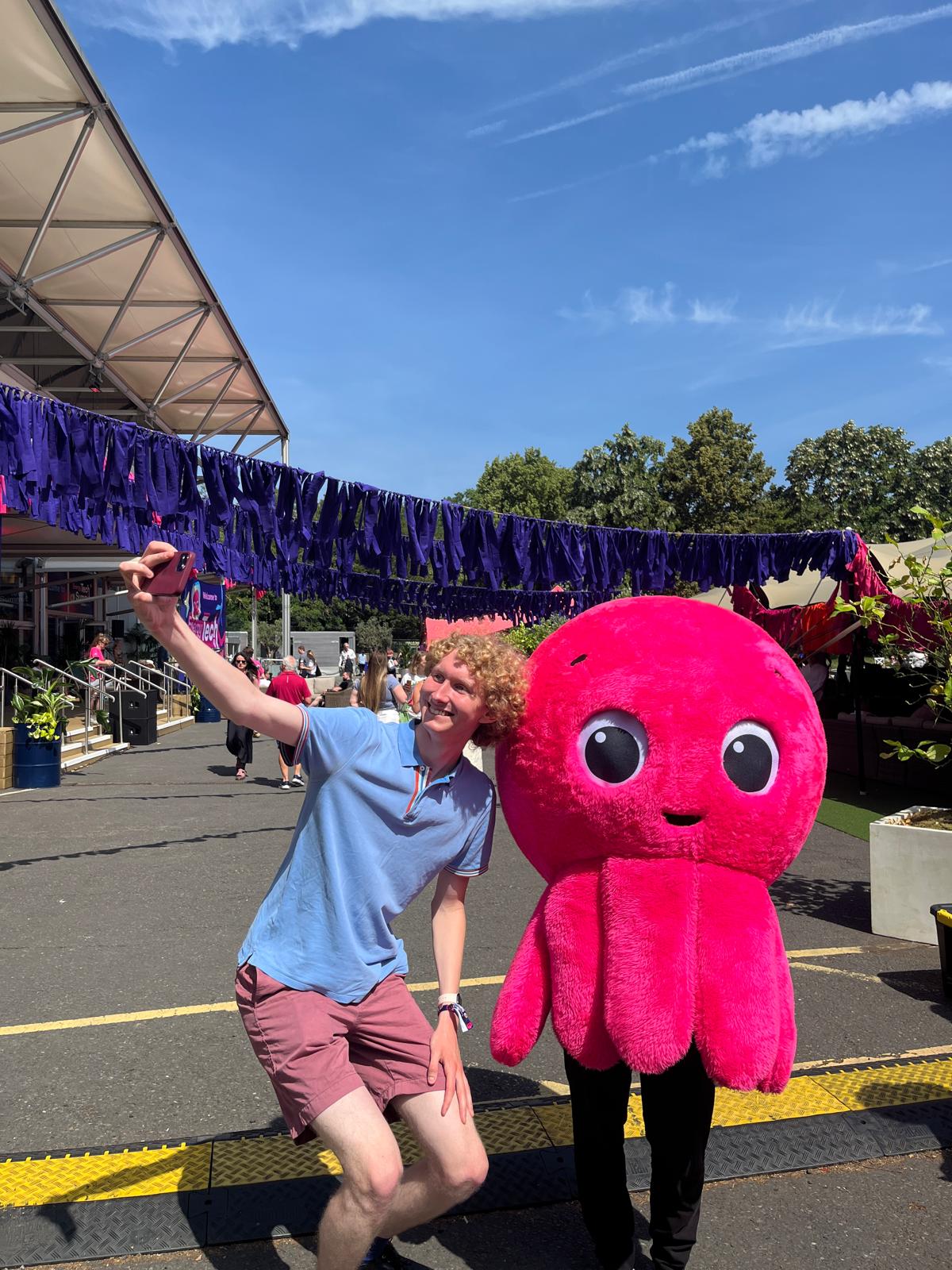 A customer with Constantine the octopus mascot