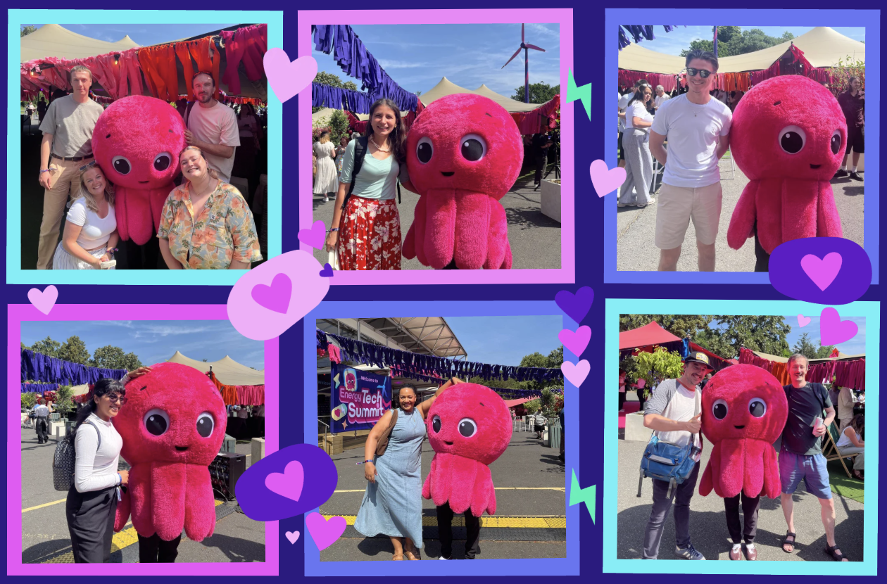 People posing with a large pink octopus mascot at an outdoor event, surrounded by colorful decorations and tents.