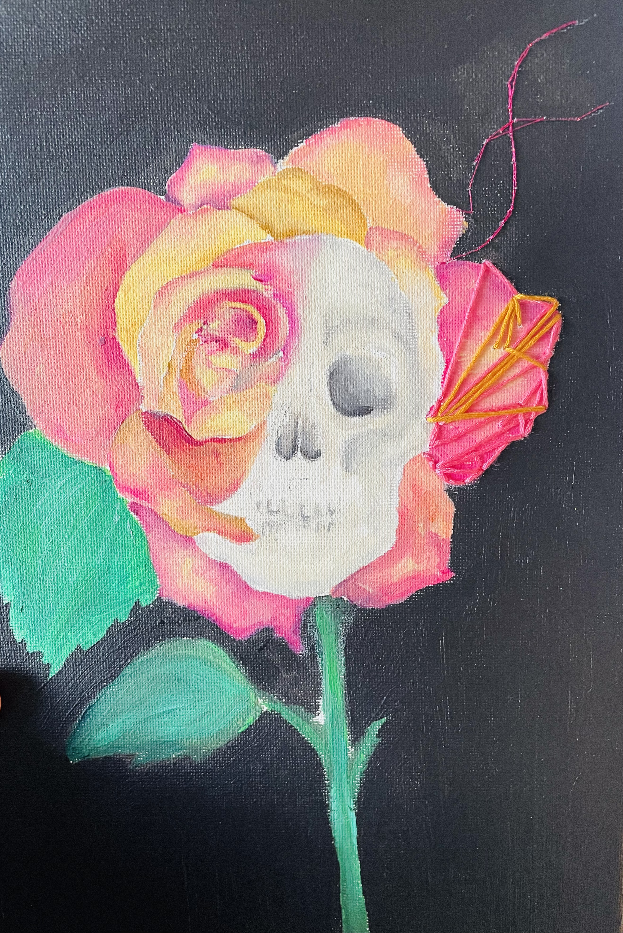 A painting of a rose with colorful petals morphing into a skull, with a pink and yellow butterfly near it on a dark background.