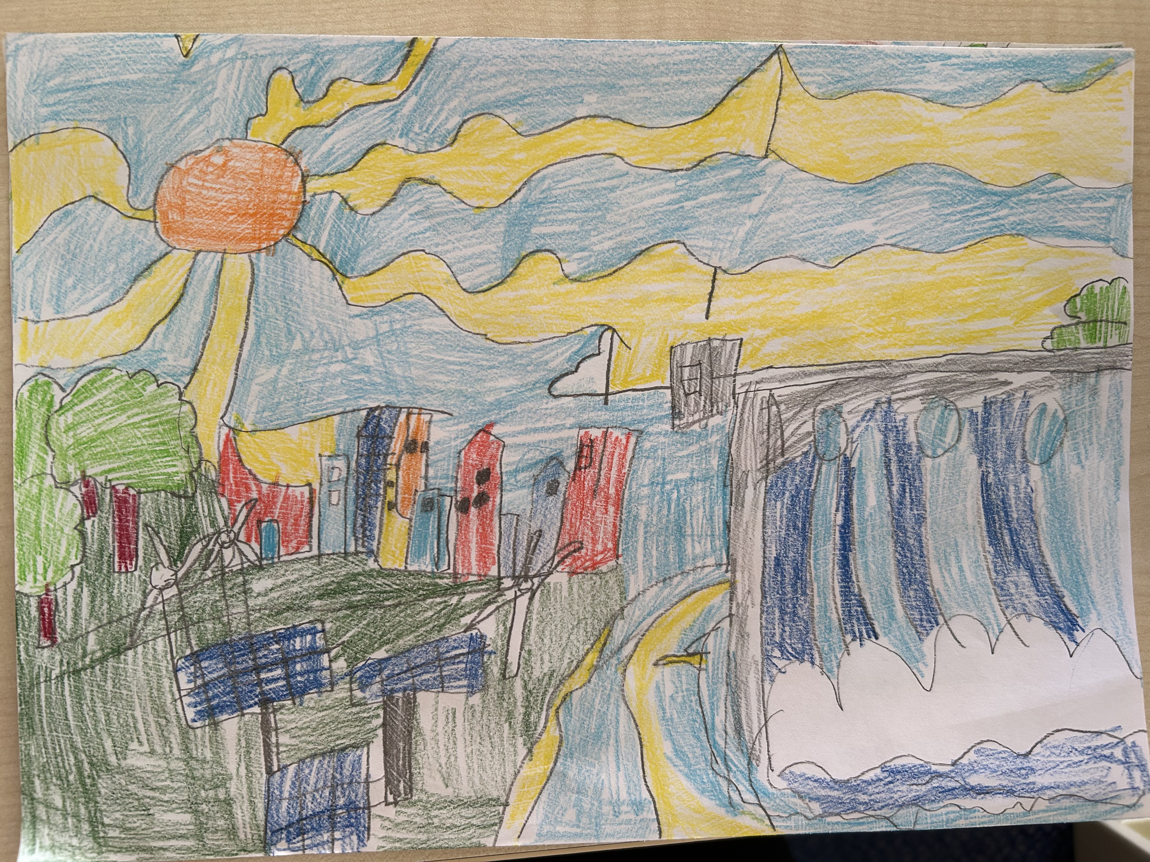 Colorful childlike drawing of a vibrant landscape with a bright sun, wind turbines, buildings, and a flowing waterfall under a blue sky.