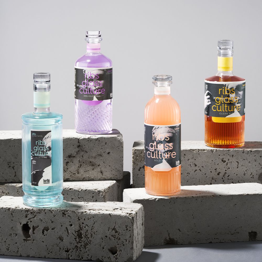 Sculpting Collection by Berlin Packaging featuring glass bottles for distilled spirits with sculpted surfaces, ribbed textures and distinctive bottle shapes, showcasing innovative glass design and premium packaging concepts.