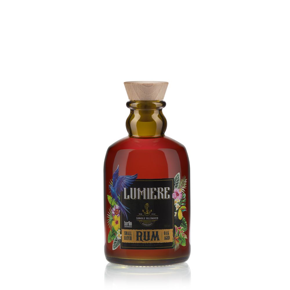 bp_em_spirits_collection_Modern-Classics_lumiere Lumière glass bottle for distilled spirits from the Modern Classics collection by Berlin Packaging, featuring an amber glass finish, rounded silhouette, wooden closure and illustrated label inspired by tropical botanical elements.