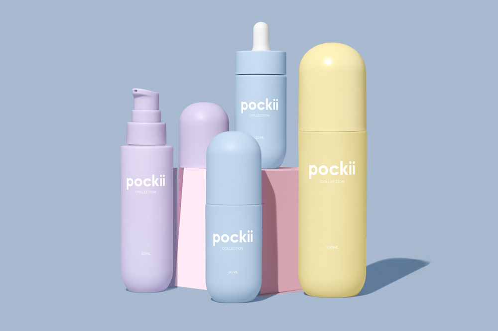 Set of bottles from the Pockii collection, suitable for both skincare and makeup, displayed on colorful geometric blocks, highlighting sustainable packaging2