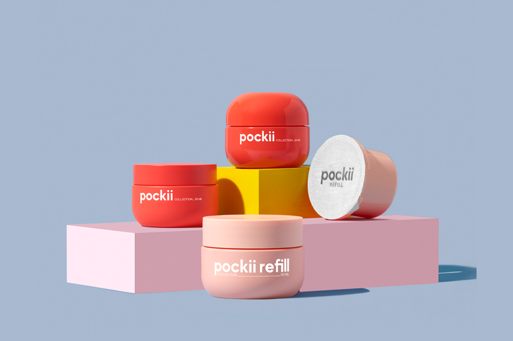 Set of refillable and non-refillable jars from the Pockii collection, suitable for both skincare and makeup, displayed on colorful geometric blocks, highlighting sustainable packaging with reusable components2