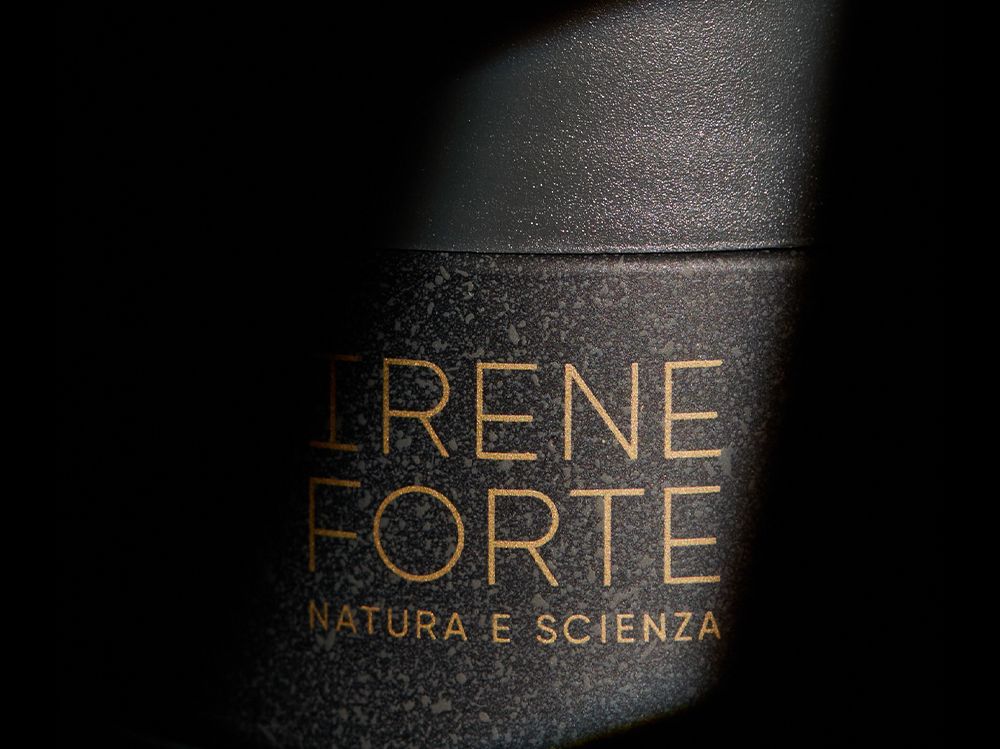Close‑up of Irene Forte Skincare primary packaging, highlighting stone‑effect surface and gold hot stamping decoration