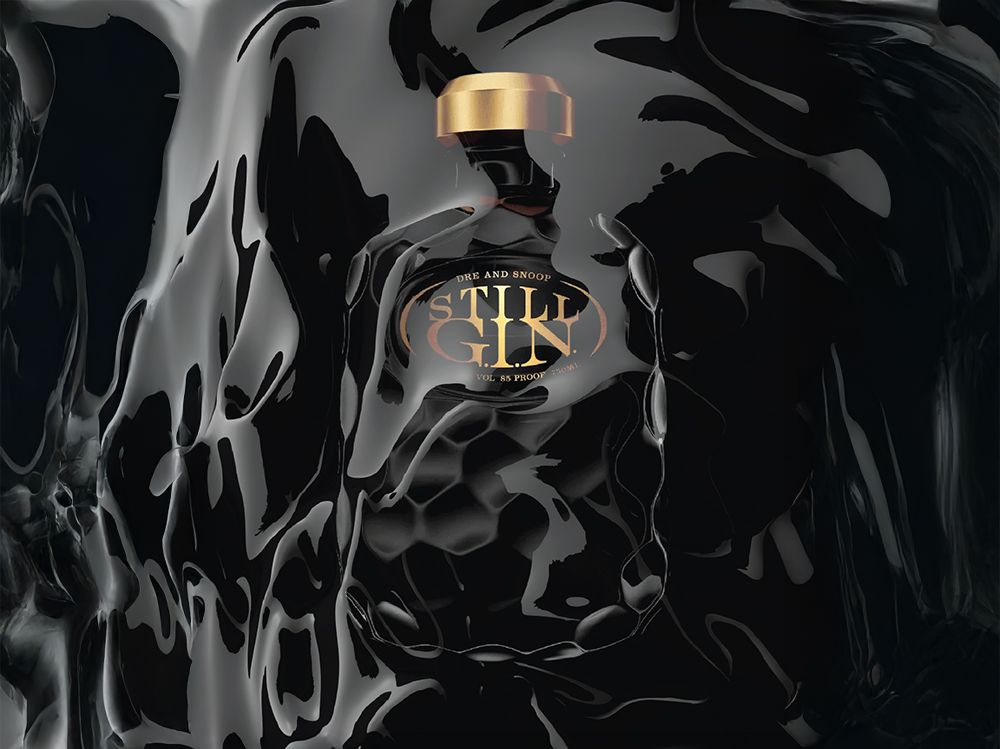 A black bottle of Still Gin with gold accents sits against a fluid, glossy black background, partially reflecting its surroundings.