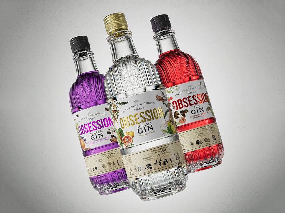 Three Obsession gin bottles featuring a custom ribbed glass design and metallic caps: a classic gin in the center, flanked by purple gin on the left and red gin on the right, each with detailed botanical labels on a neutral background.