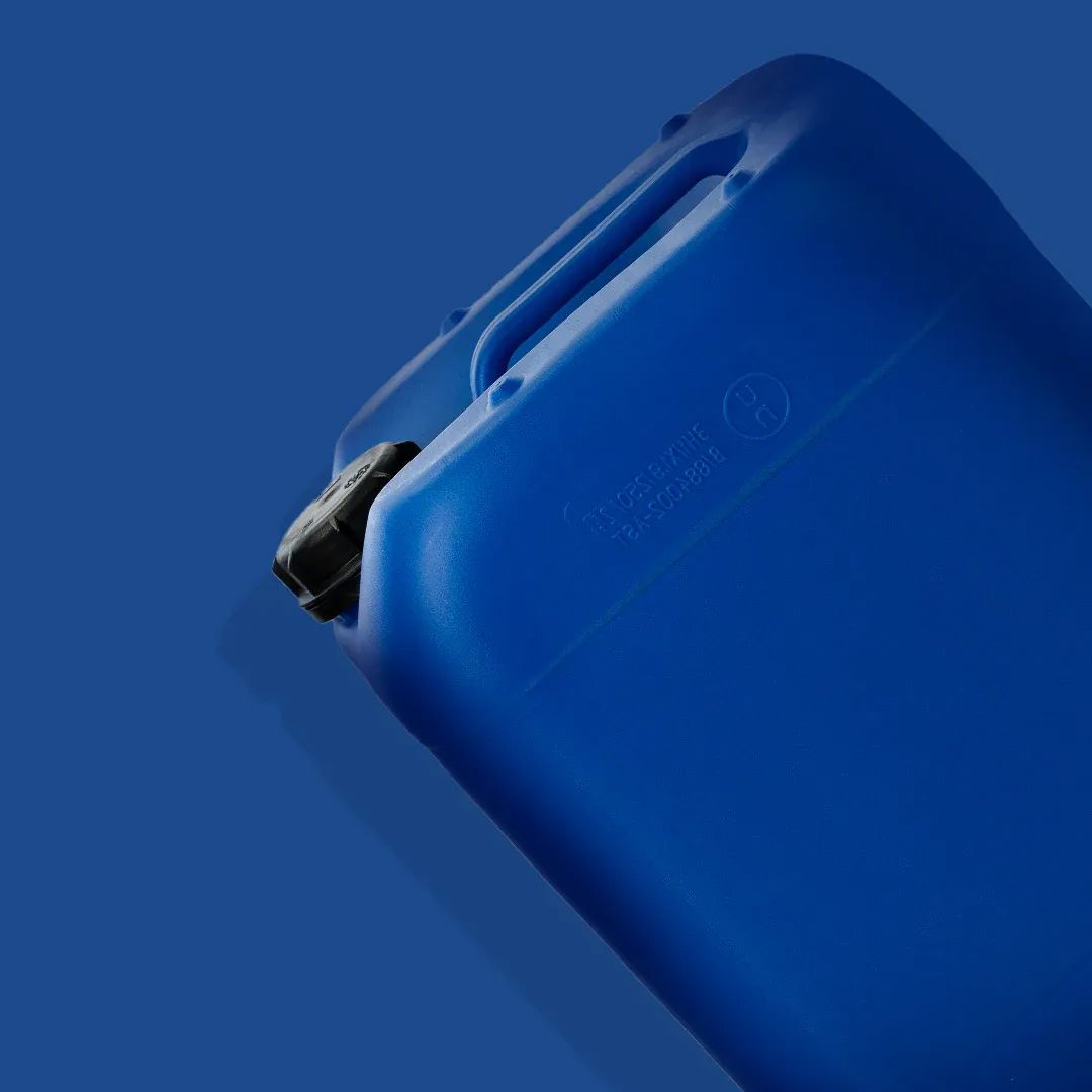 Close-up of a blue plastic jerry can with a black cap against a blue background.