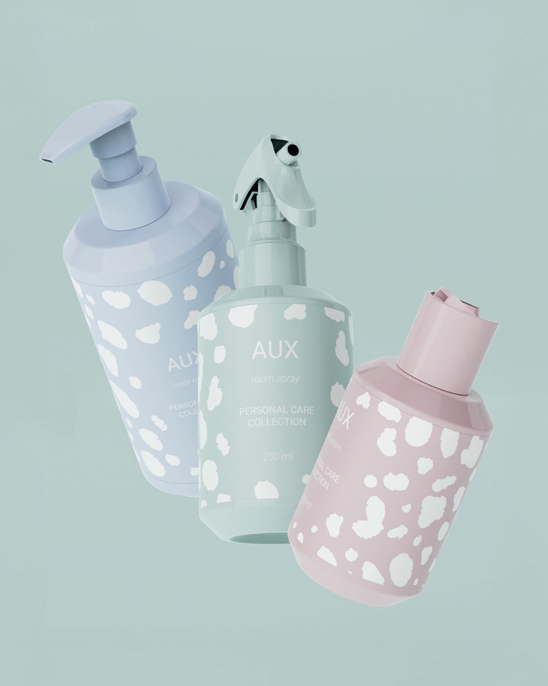 Three pastel-colored AUX personal care bottles with polka dot patterns, floating against a light teal background.