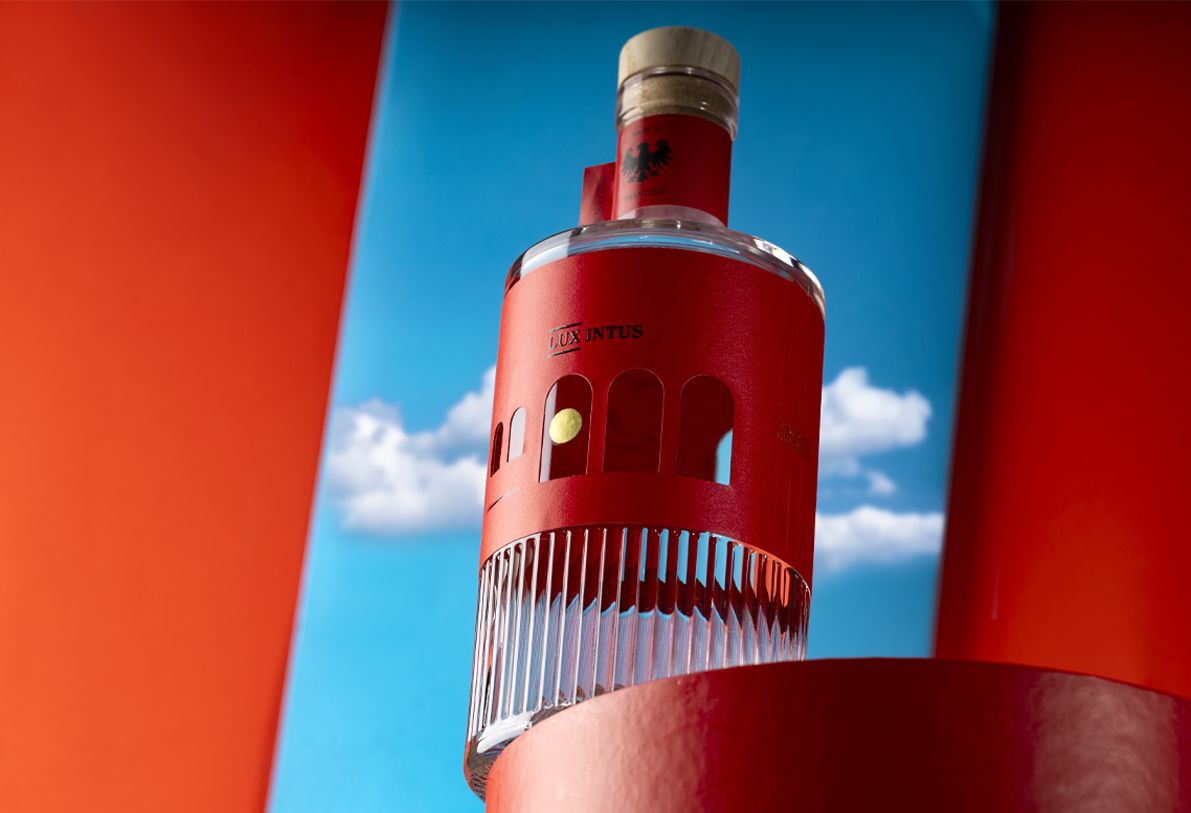 Belleville Ribs glass bottle for spirits by Berlin Packaging customized by Killer Idea, featuring red wraparound label with cut-out details for distinctive packaging design within the Ginnasium project.