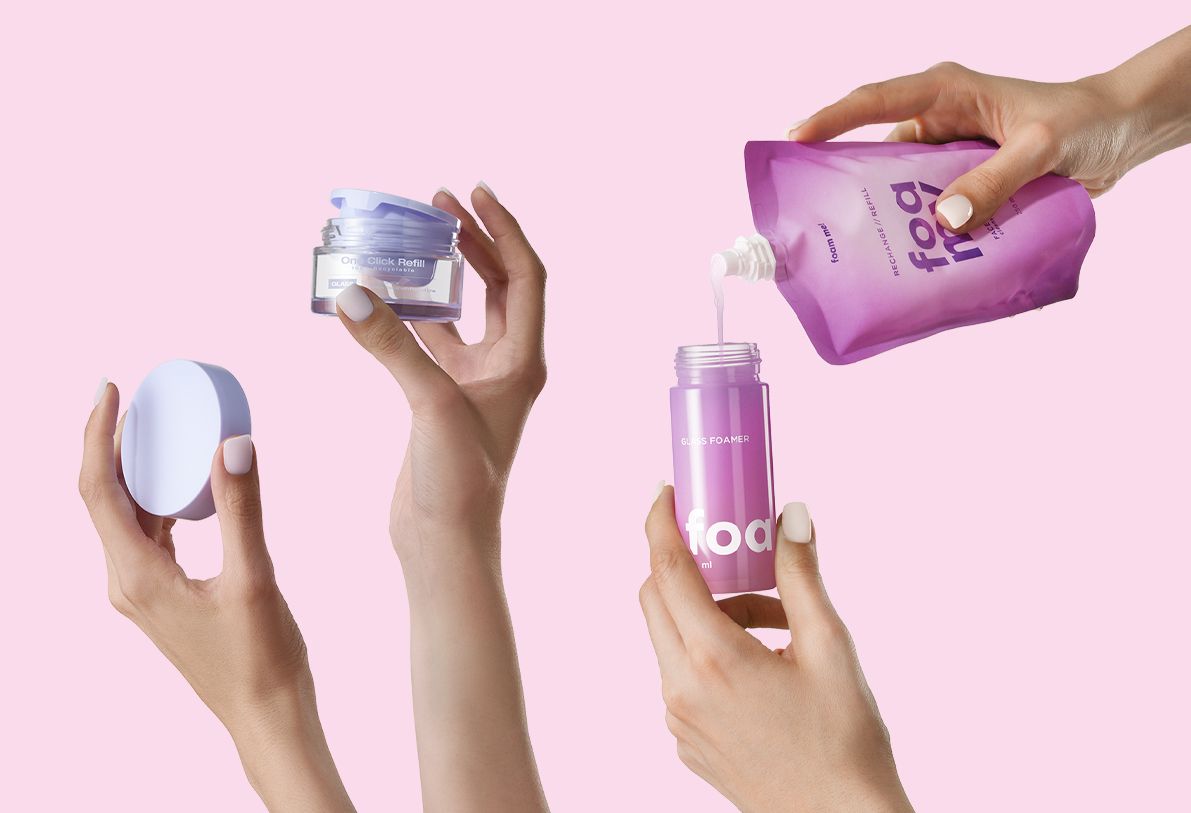 bp_em_news_beauty-world-refill-day-cover Refillable packaging solutions by Berlin Packaging Beauty including One Click Refill cosmetic jar and Foamy glass foamer bottle with pouch, demonstrating sustainable beauty refill systems on pink background.