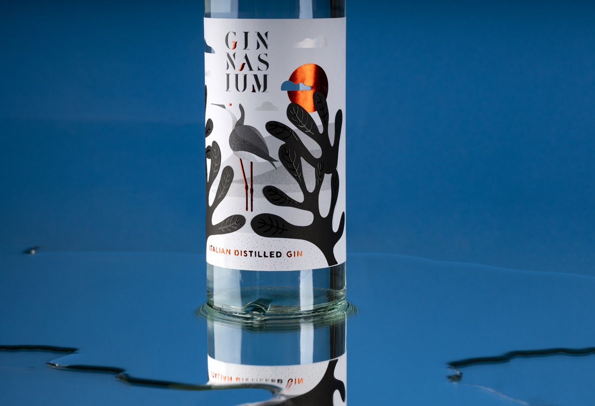 Helium Mixology 700 ml glass bottle for spirits by Berlin Packaging customized by Mark Design, created for the Ginnasium project, featuring illustrated front label with hot stamping accents and apothecary-inspired perfume design.