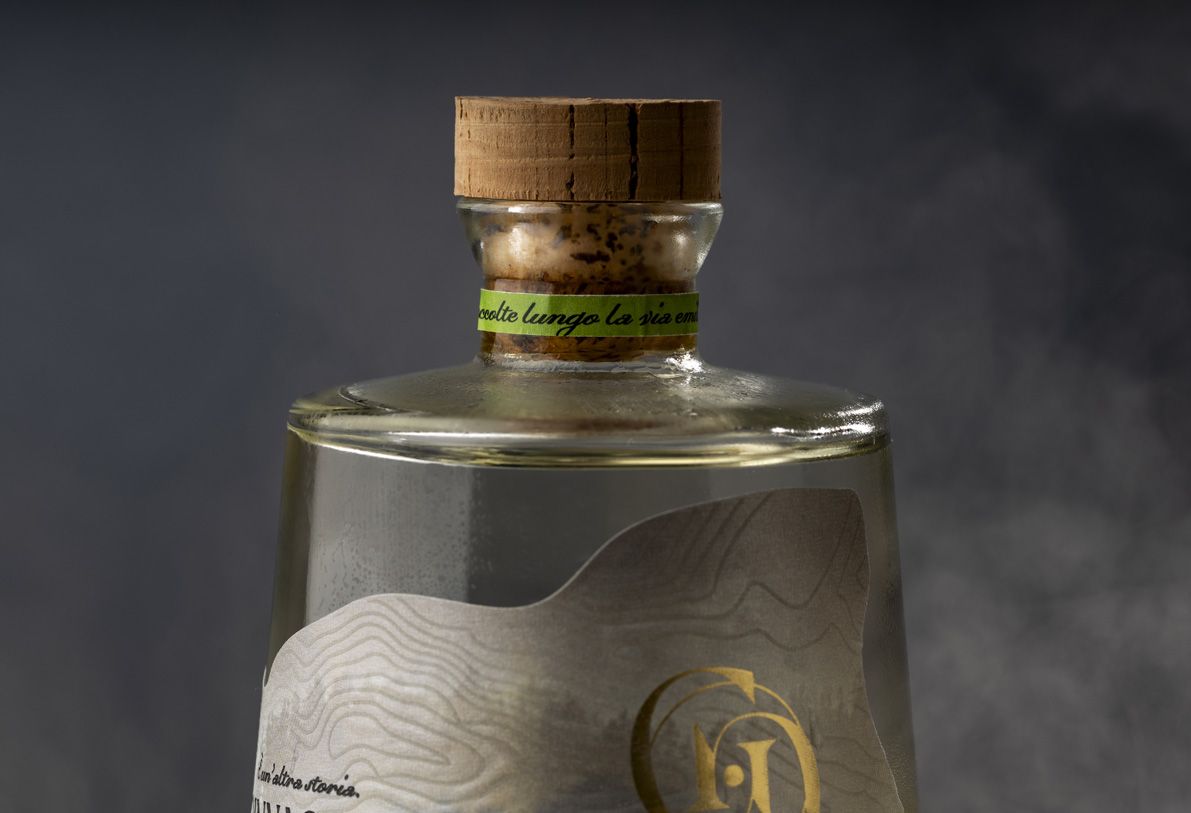 Alchemist glass bottle for spirits by Berlin Packaging customized by Rewot creative agency, created for the Ginnasium project, detail of cork closure and neck area with shaped label.