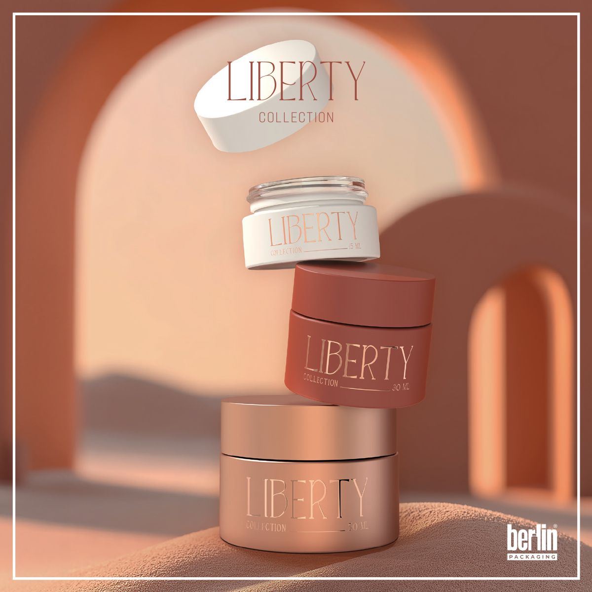Three Liberty Collection glass jars for beauty products in 15 ml, 30 ml, and 50 ml sizes, displayed in warm-toned architectural setting. Elegant design with matte and metallized finishes. Premium skincare packaging.