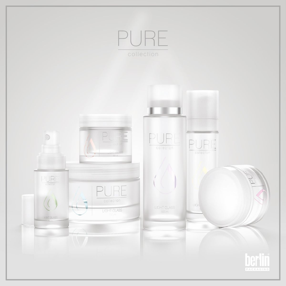 Berlin Packaging Pure Collection group shot of elegant glass bottles and jars in various sizes, showcasing minimalist design, frosted finishes, and premium look for skincare and beauty products on a grey background.