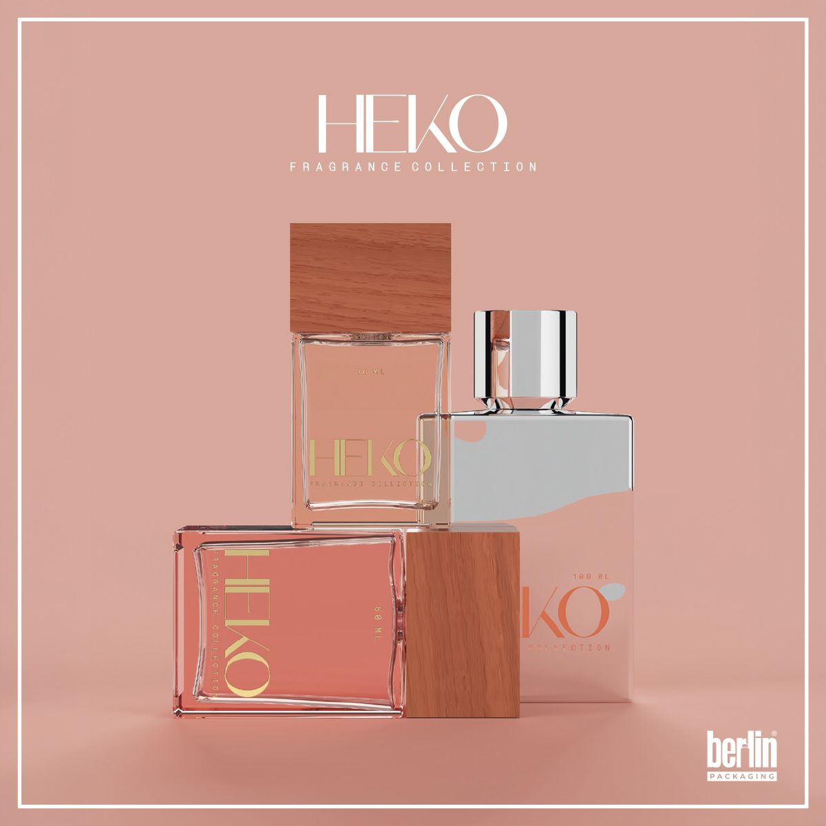 Heko Fragrance packaging collection by Berlin Packaging featuring three rectangular glass perfume bottles in transparent and light pink tones with wooden and metallic caps, displayed on a solid pastel pink background.