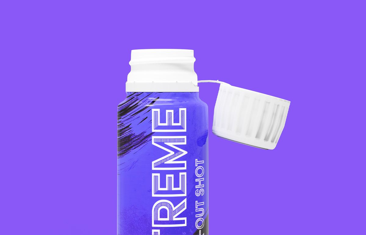 Close-up of X-Treme pre-workout shot bottle with open white cap on a purple background Close-up of X-Treme pre-workout shot bottle with open white cap on a purple background