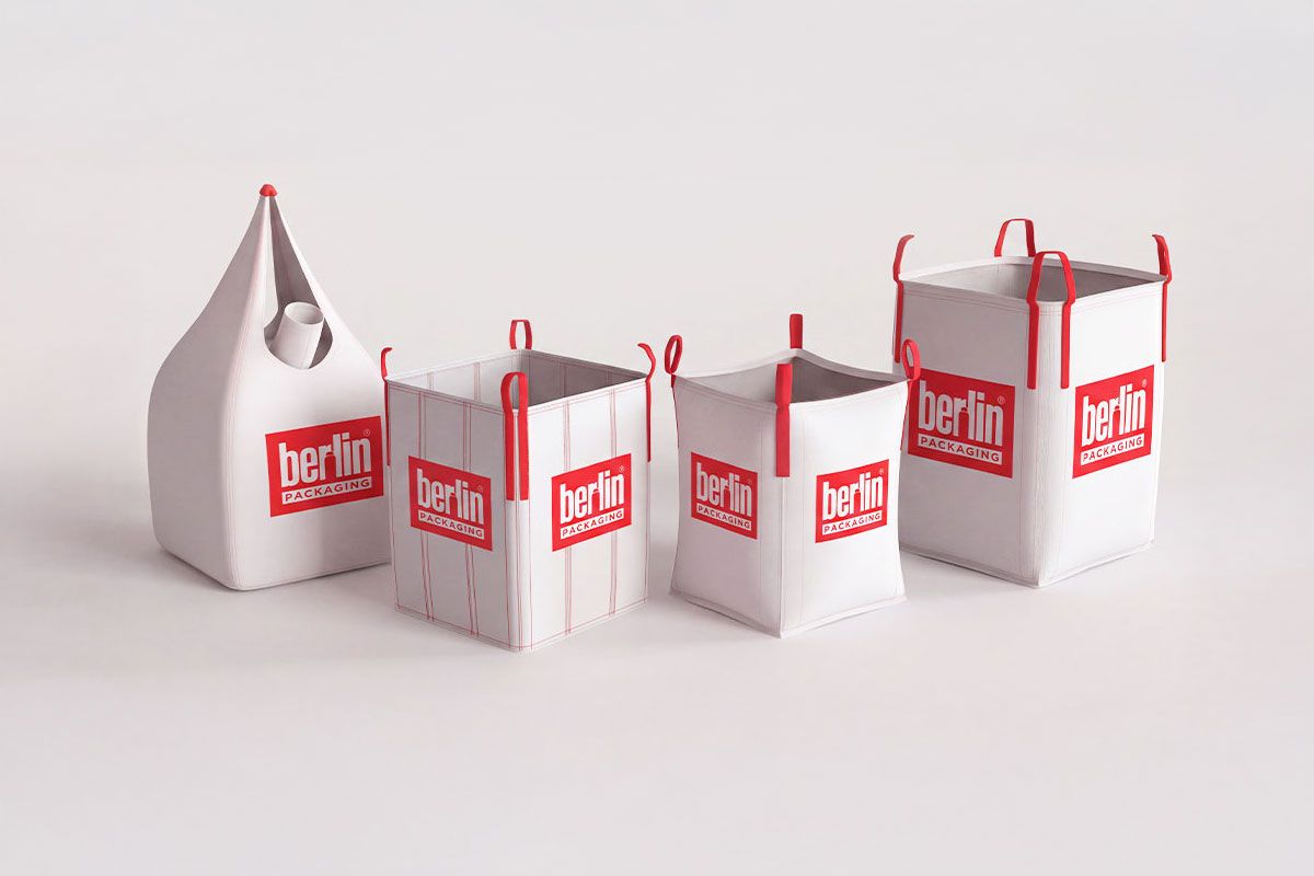 Four white and red fabric bags of varying shapes and sizes with "Berlin Packaging" logos on a light background.