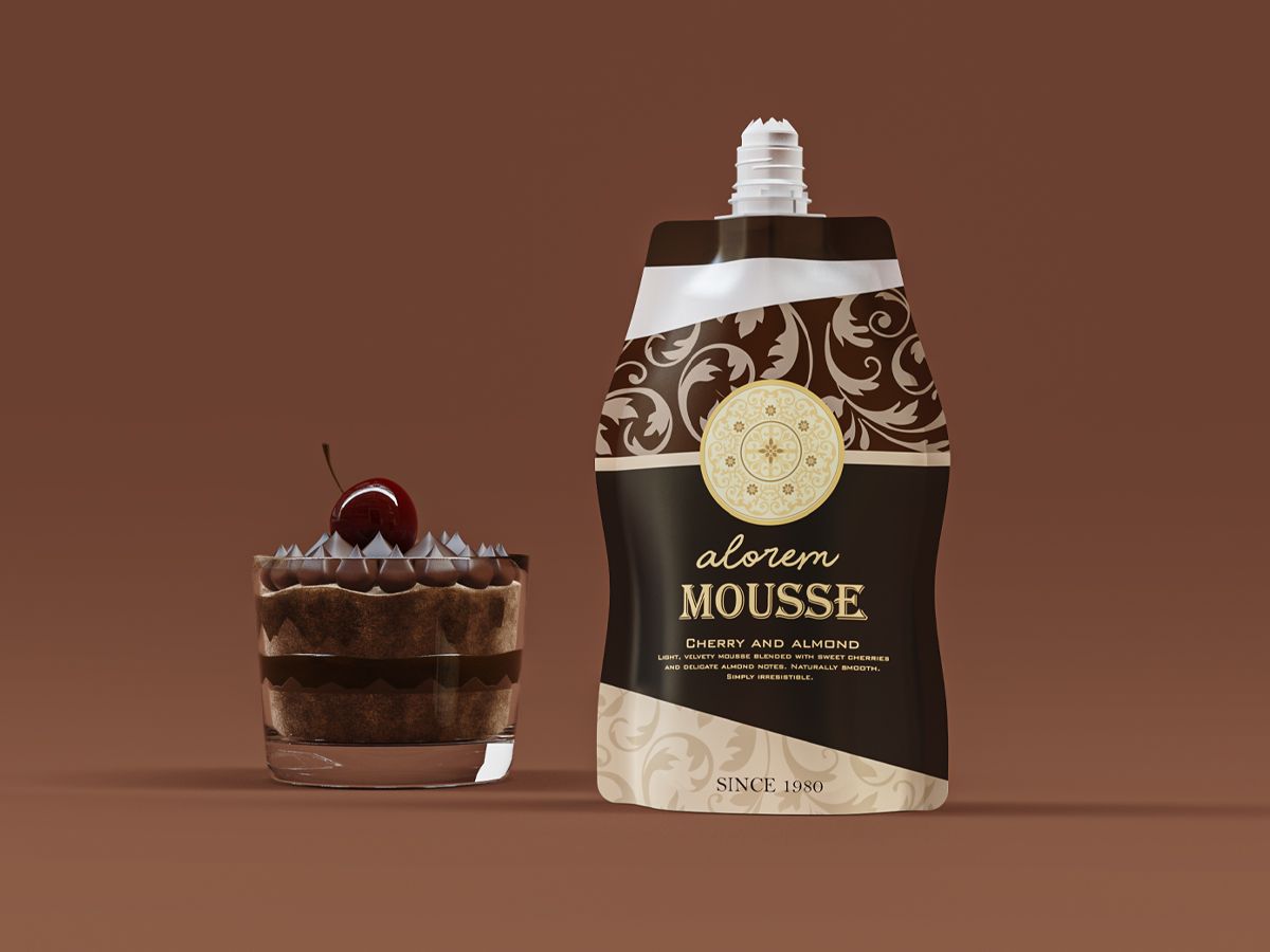 Chocolate mousse in a glass topped with a cherry next to a decorative spout pouch labeled 'Alorem Mousse – Cherry and Almond' on a brown background. Chocolate mousse in a glass topped with a cherry next to a decorative spout pouch labeled 'Alorem Mousse – Cherry and Almond' on a brown background.