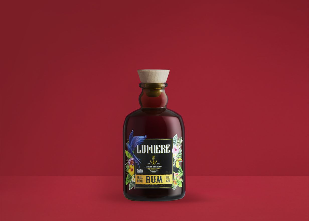 bp_em_spirits_collection_Modern-Classics_img final Lumière glass bottle for distilled spirits from the Modern Classics collection by Berlin Packaging, combining a classic rum-inspired shape, wooden closure and illustrated tropical label design for premium spirits packaging.