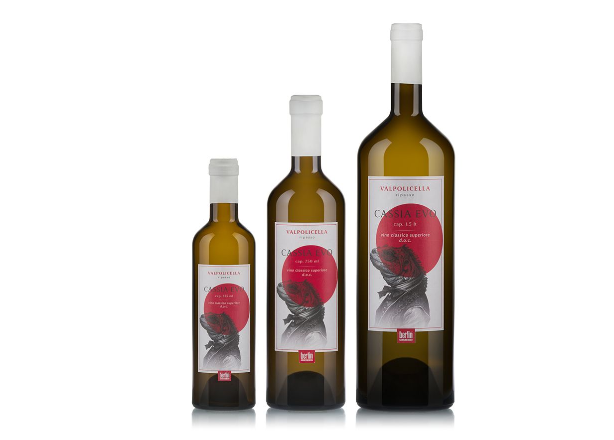Three Cassia Evo bottles by berlin packaging with labels, featuring a red circle and a black-and-white illustration.