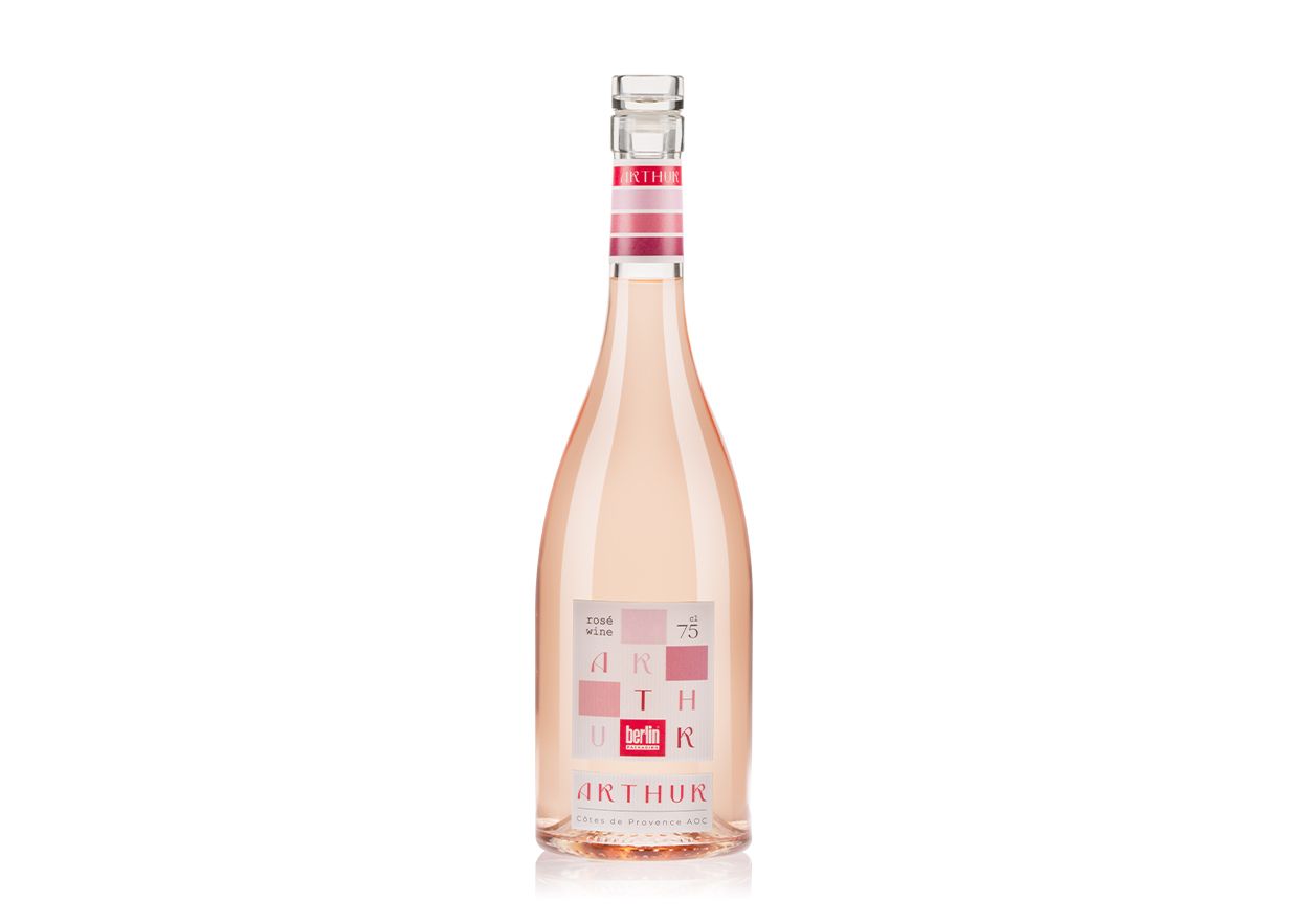 Arthur bottle by Berlin Packaging filled with rosè wine with a pink and white design, set against a white background.