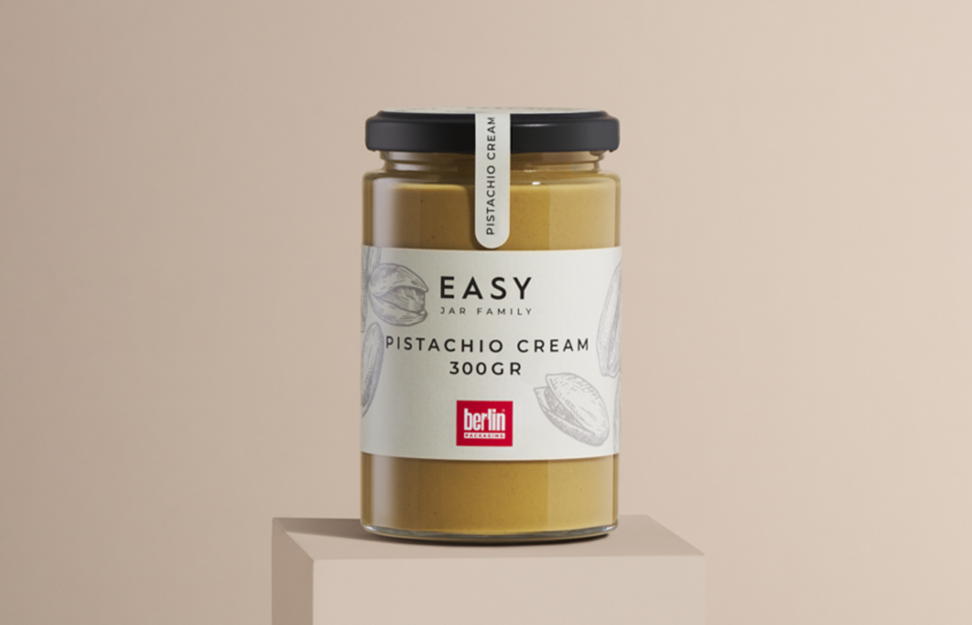 Glass jar of pistachio cream from the Easy Jar Family collection, 300 grams, with a white label decorated with pistachio illustrations and the Berlin Packaging logo.