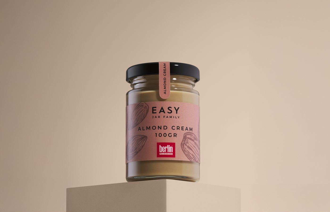 Glass jar of almond cream from the Easy Jar Family collection, 100 grams, with a pink label featuring almond illustrations and the Berlin Packaging logo.