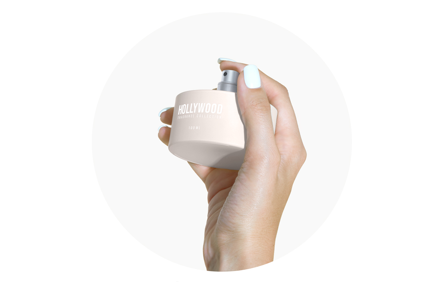 BP_EM_INTERNATIONAL_NEWS_HOLLYWOOD_STEP2 Hand spraying Hollywood Fragrance Collection perfume bottle with sleek matte finish and modern stone-inspired cap. Premium fragrance packaging design.