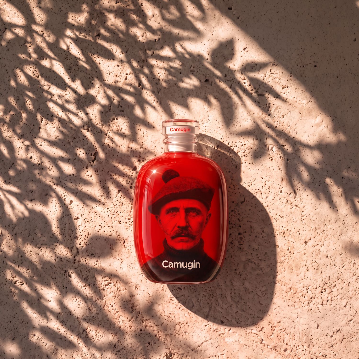 A Stone bottle by Berlin Packaging for Camugin on a textured surface, featuring an older man's portrait and surrounded by tree shadow patterns.