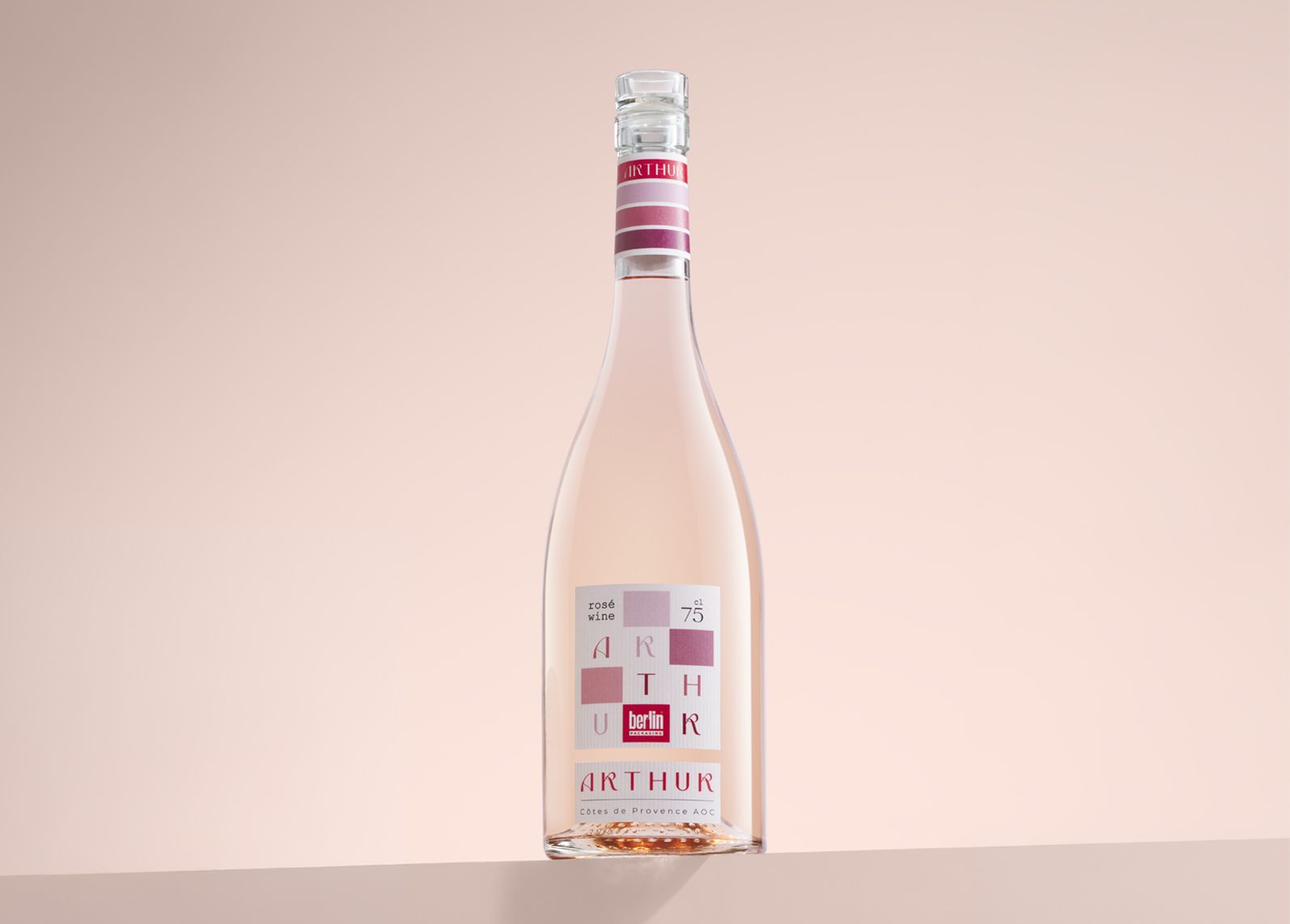 Arthur bottle for rosè wine, featuring a modern design on a pale pink background.