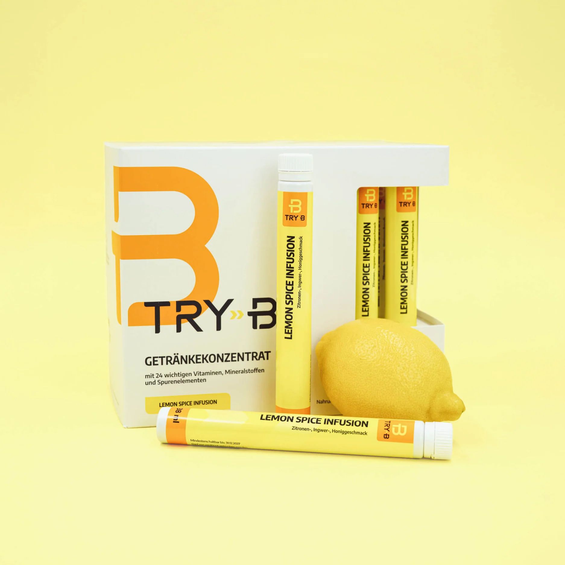 TRY B Lemon Spice Infusion beverage concentrate box with four yellow sticks displayed alongside a whole lemon