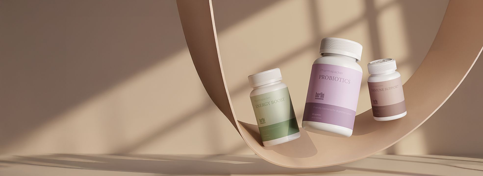 Three probiotic bottles with green, purple, and pink labels are balanced on a curved wooden surface against a beige background.