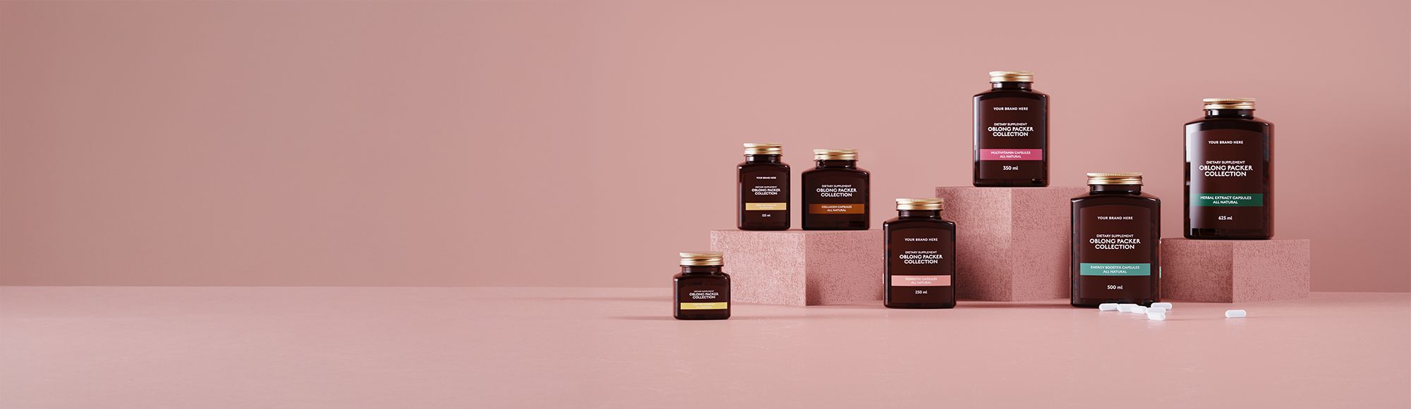 A collection of brown bottles with gold caps on pink platforms against a pink background. Some bottles have colorful labels.