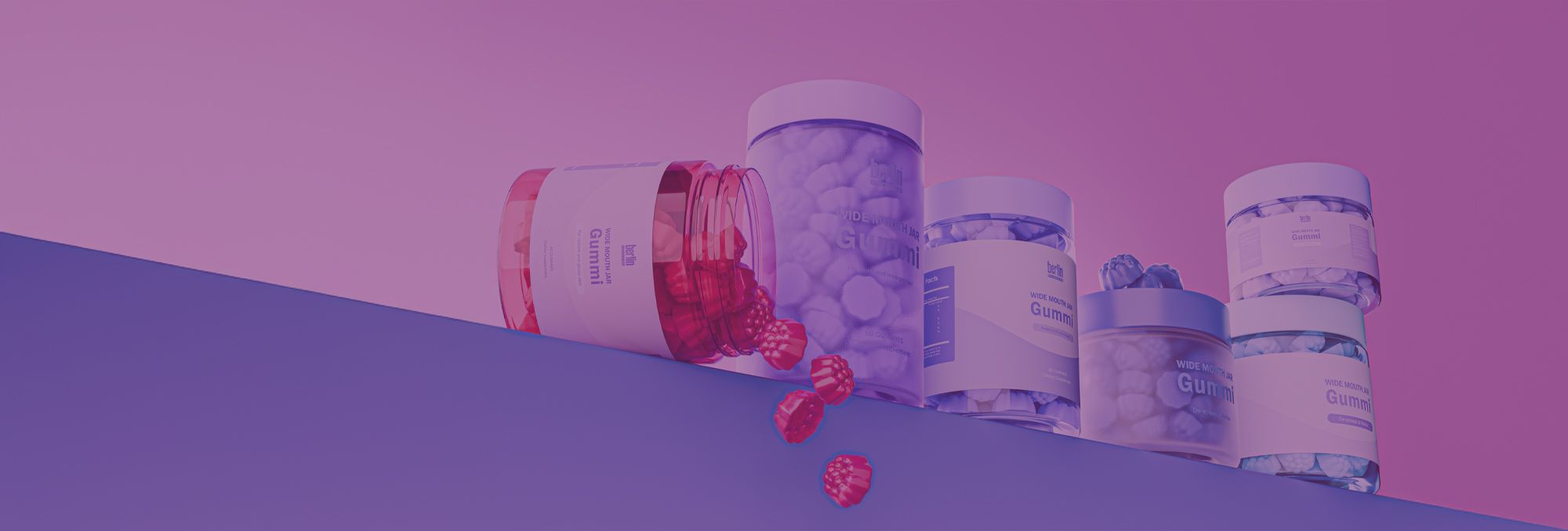 Colorful gummy vitamin jars against a pink and blue gradient background, with scattered red gummies in the foreground.