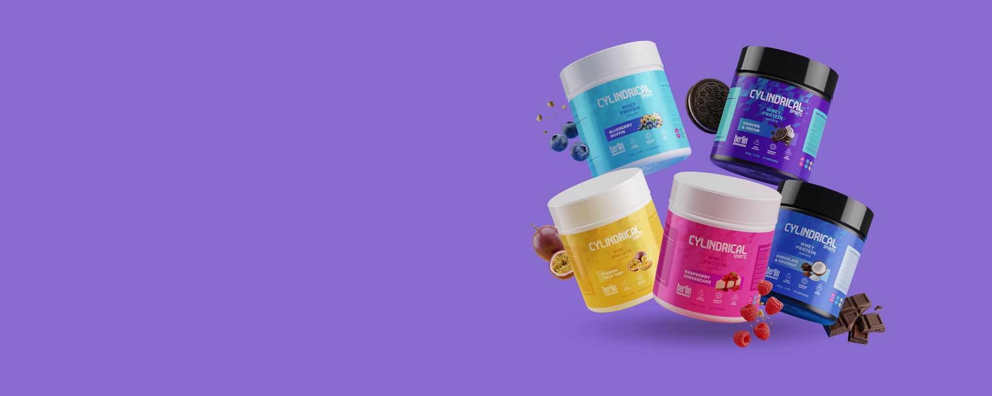 Five colorful protein powder tubs are floating on a purple background, each featuring different flavors and fruit illustrations.