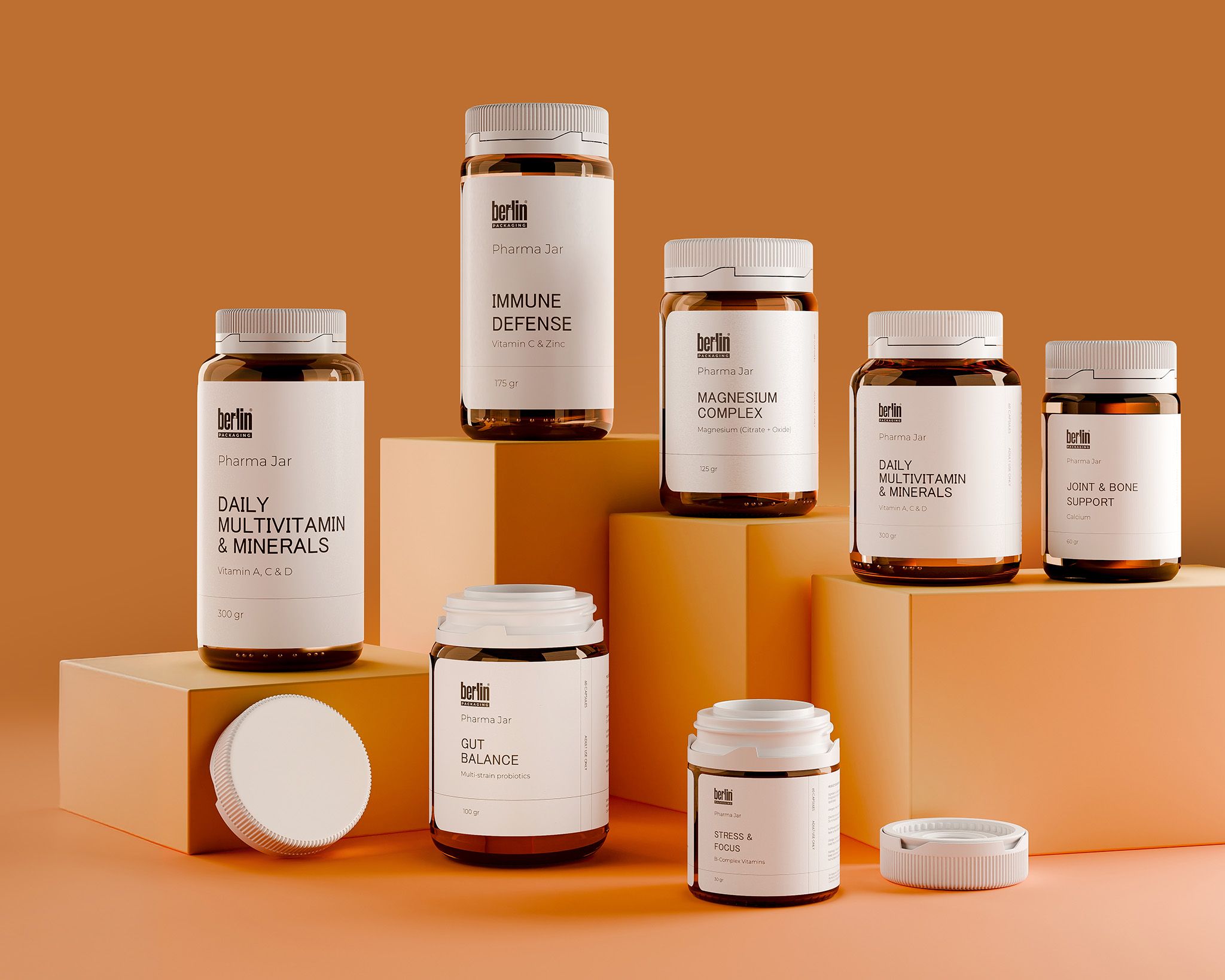 Glass Pharma Jars 1a Assorted vitamin and supplement bottles on orange blocks, labeled for immune defense, daily vitamins, magnesium, gut balance, and joint support.