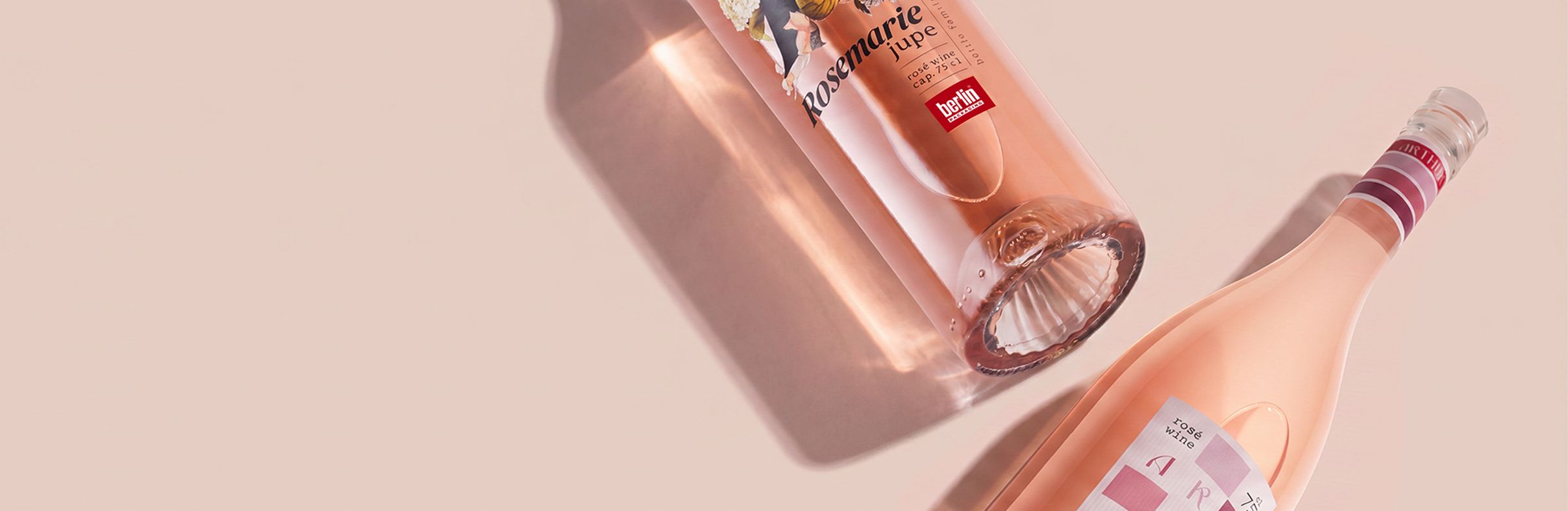 Rosé Wine Collection by Berlin Packaging featuring Rosemarie Jupe and Arthur glass bottles filled with rosé wine, showcasing distinctive bottle shapes, premium label designs and elegant packaging concepts for rosé wine brands.