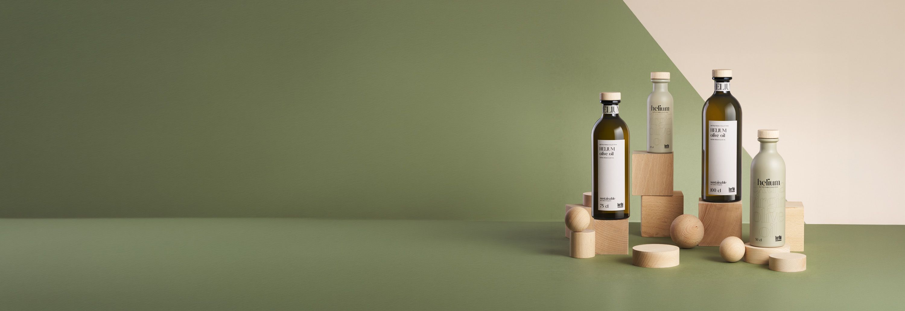 Helium bottles collection for olive oil on wooden blocks with a green and beige background, minimalist and sustainable aesthetic.