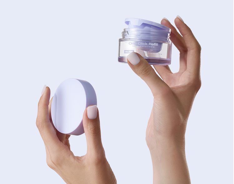 One Click Refill by Berlin Packaging Beauty, refillable cosmetic jar with one-click refill cup held by hands, showcasing easy refill mechanism and reusable skincare packaging system.
